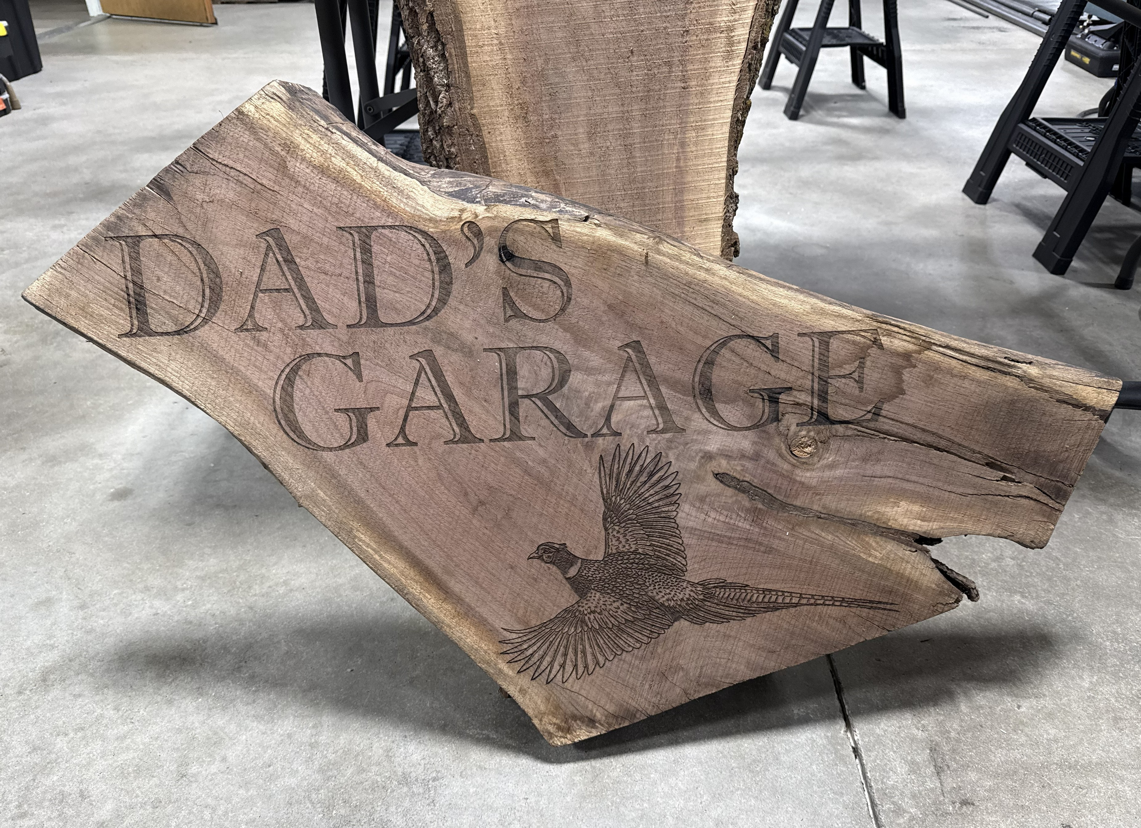 CO₂-engraved live-edge wood sign with pheasant artwork